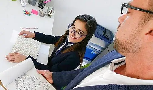 Business babe with glasses gave himself the teacher on the Desk in Col...